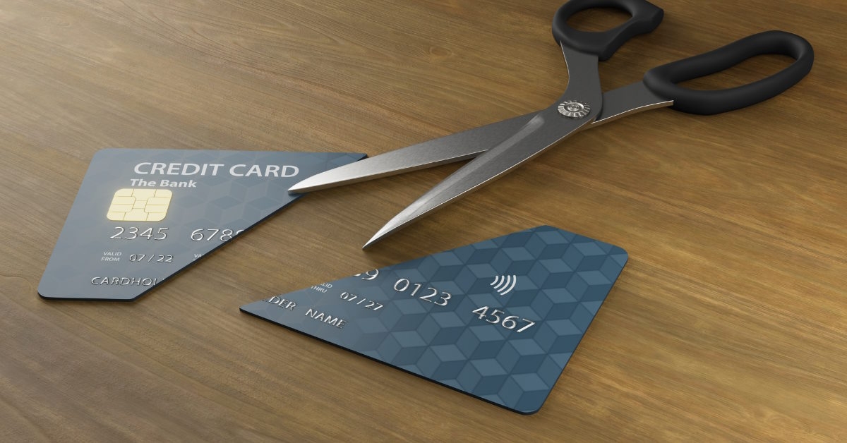 card cut in half besides scissor