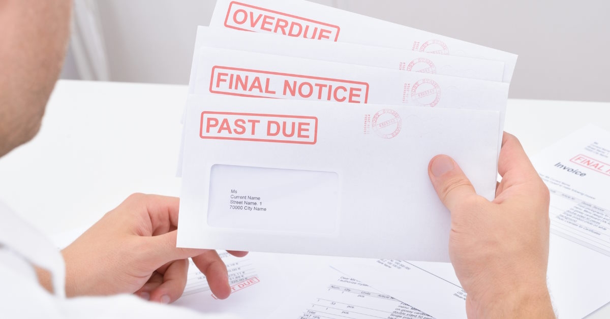 man holding overdue legal notices