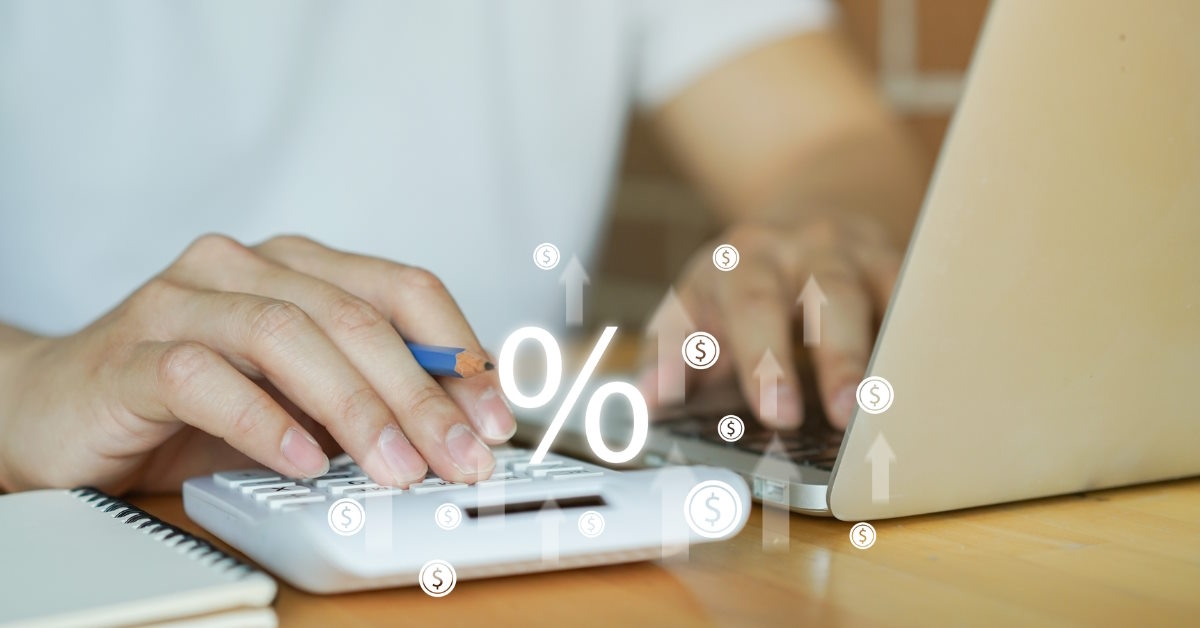 man calculating expenses using laptop