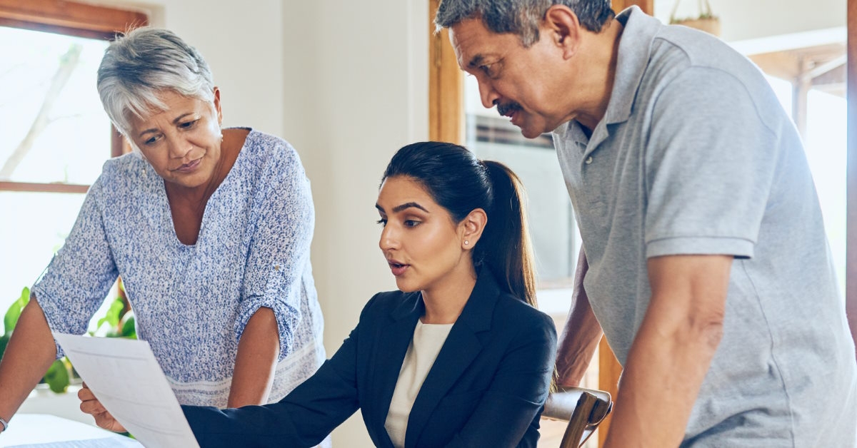 Senior couple consulting female finance advisor