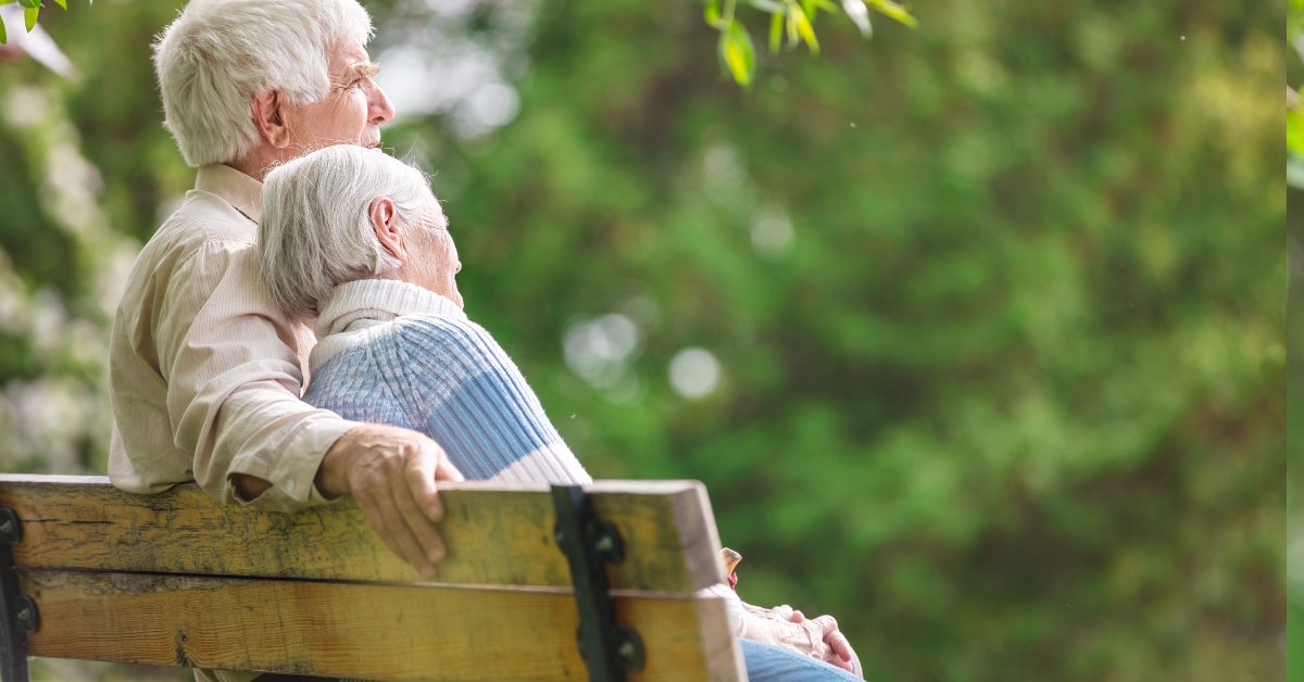 Senior couple relaxing on park bench
