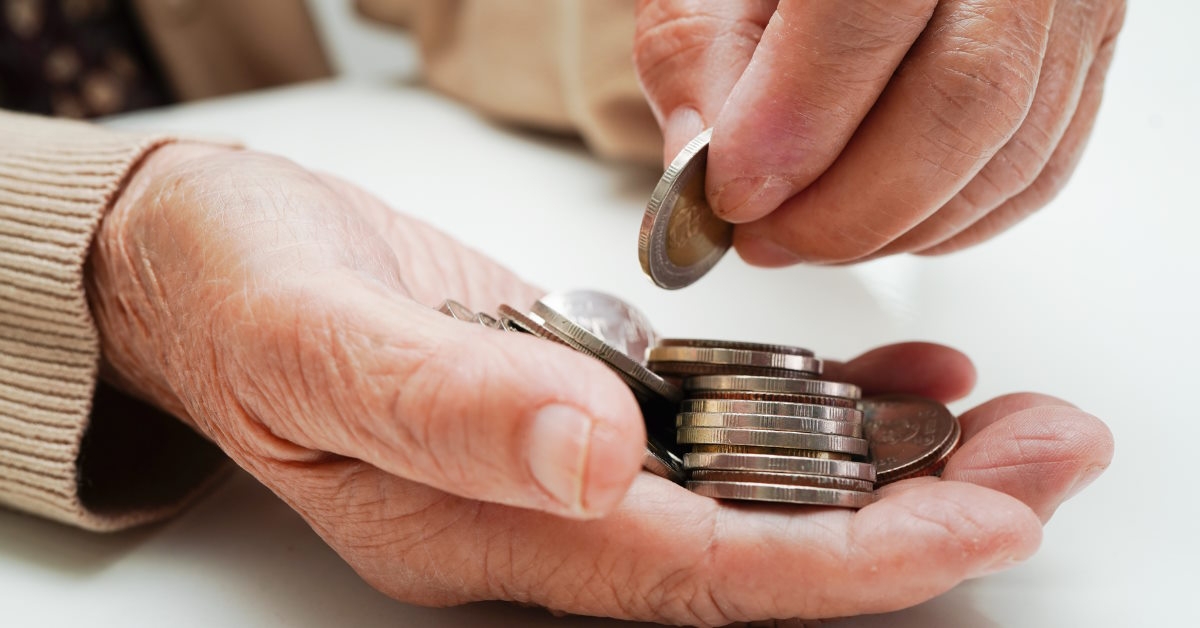 Woman stacking pennies in hand