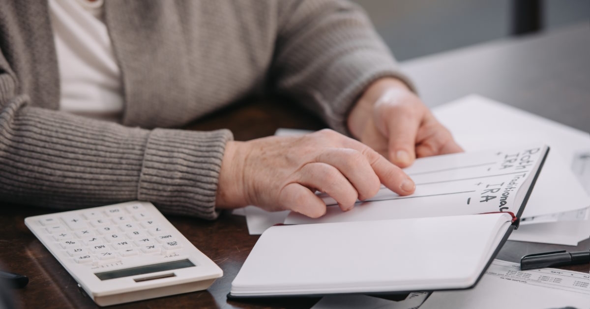 Senior lady pointing to IRA on notebook