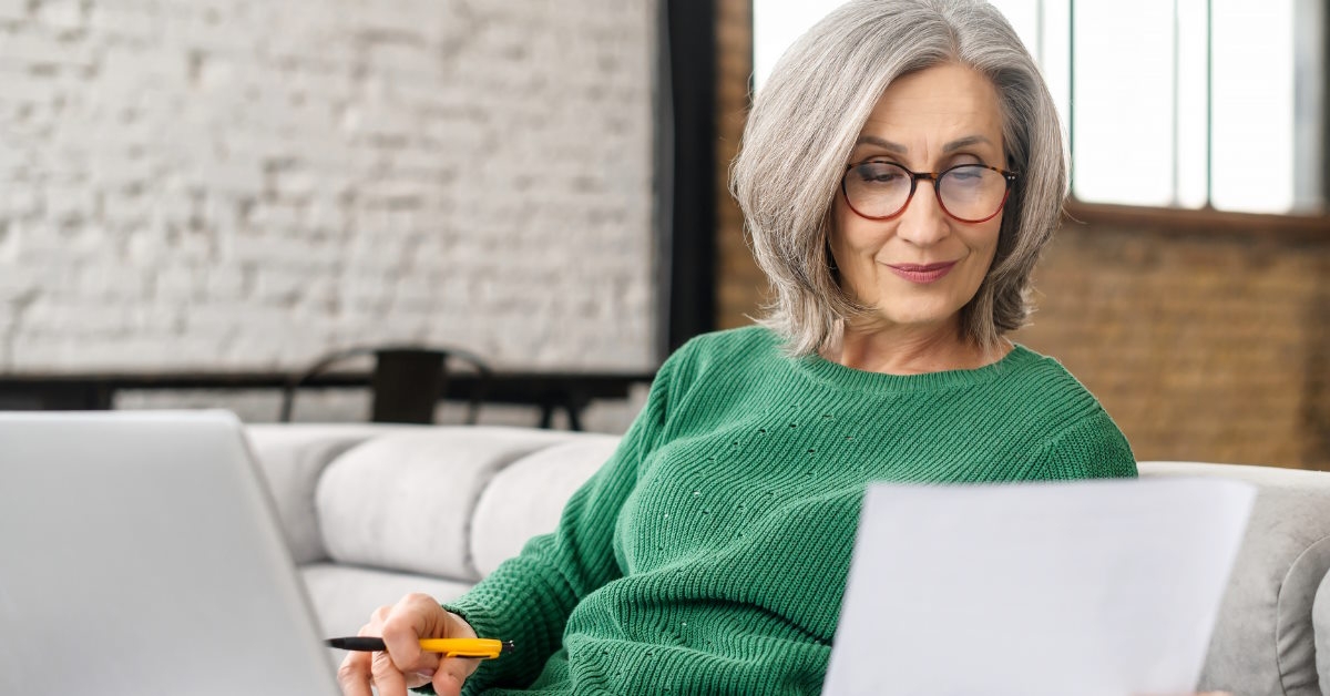 Senior woman reviewing bills at home
