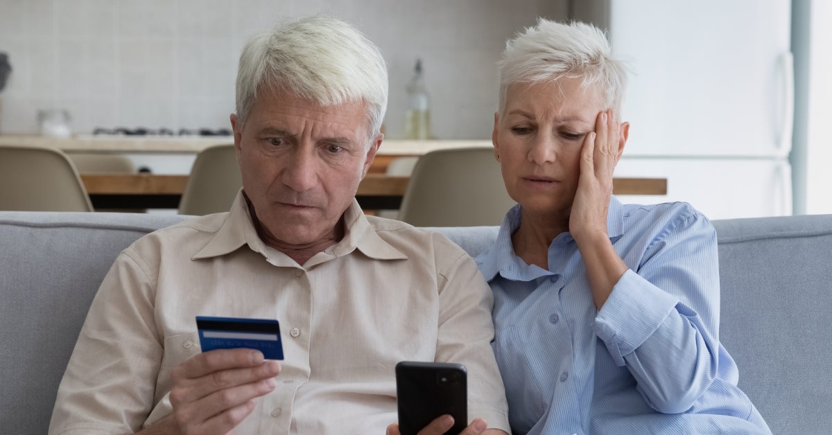 senior couple shocked while shopping online