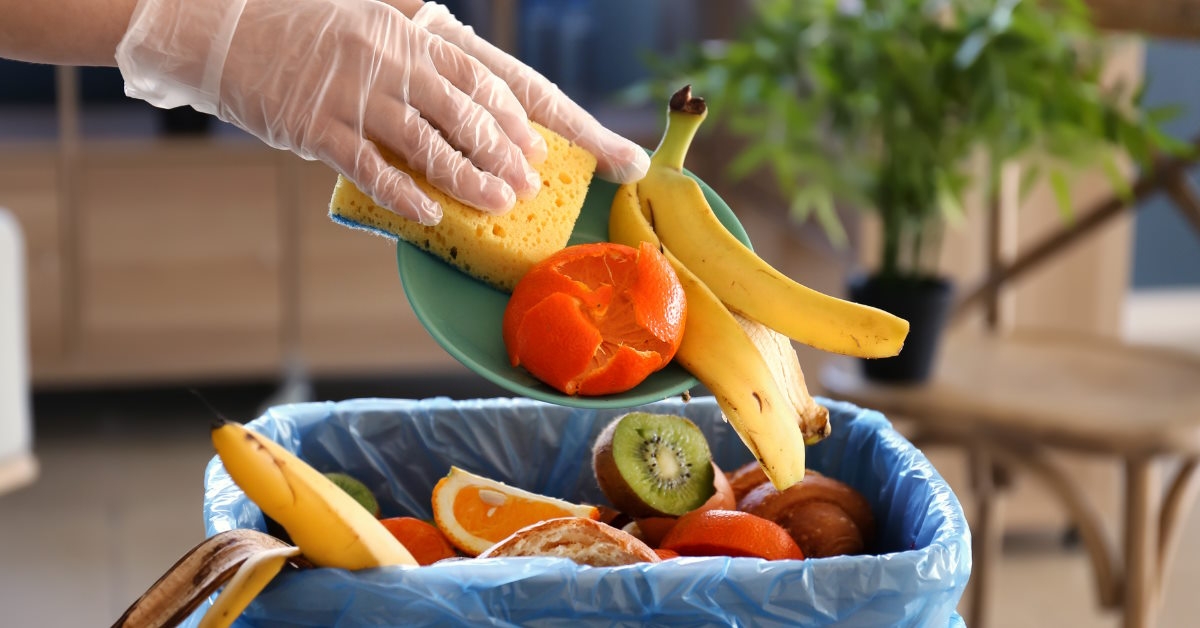Woman disposing food in trash bin