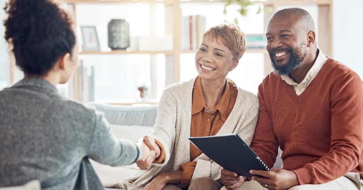 couple shaking hands with advisor