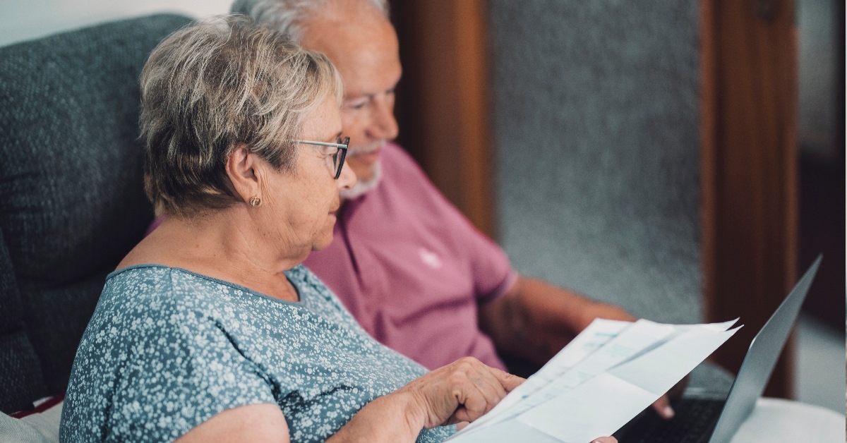 couple paying bills via banking app.