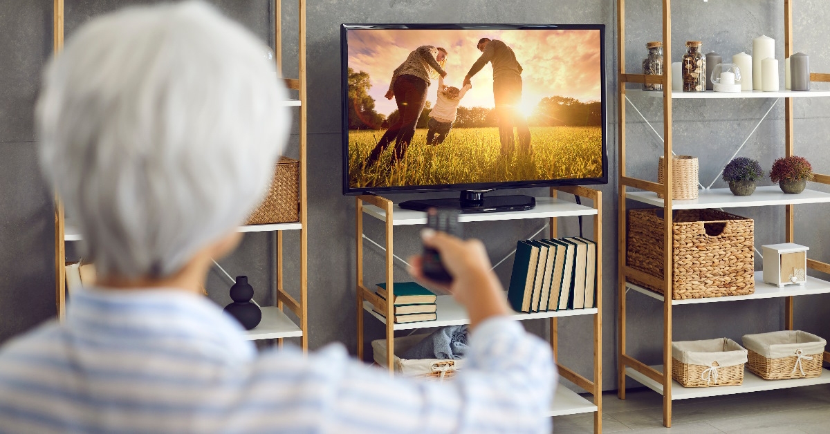 Woman enjoying watching television.