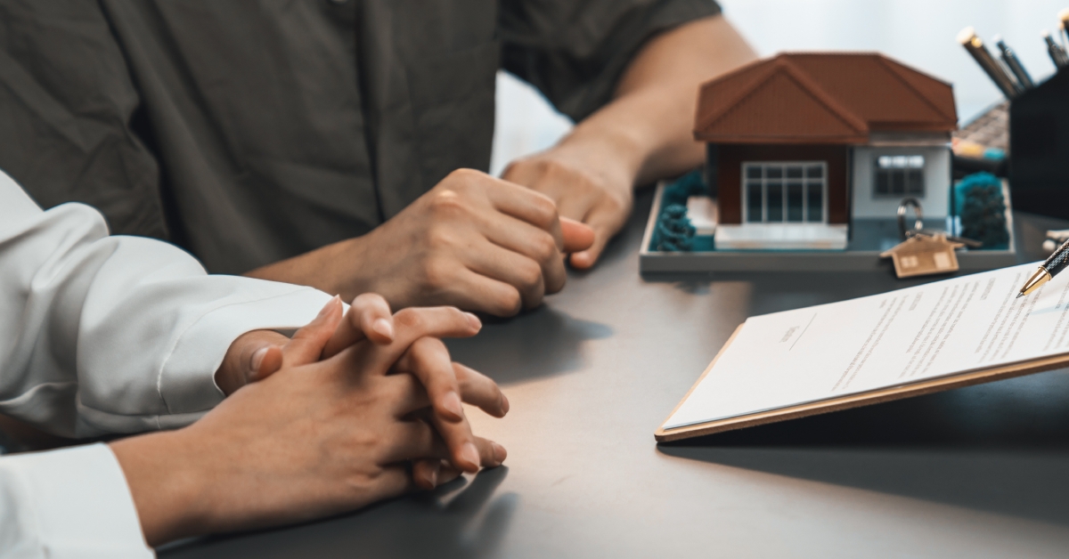 Couple signing paperwork for a house