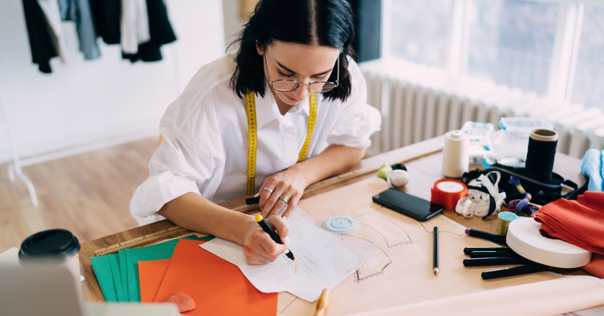 artist drawing sketches of new clothes