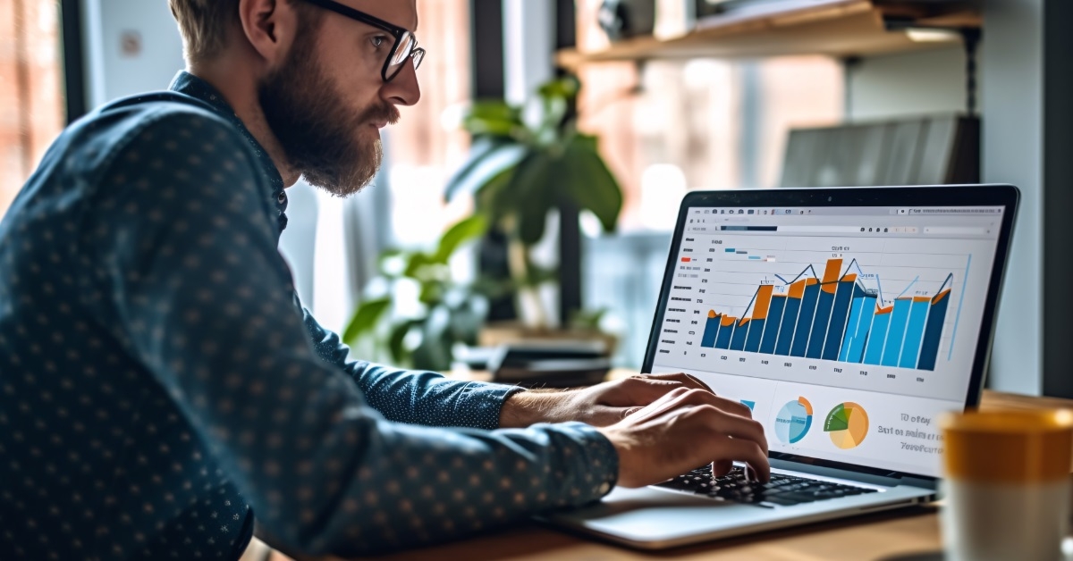 man preparing data charts on laptop