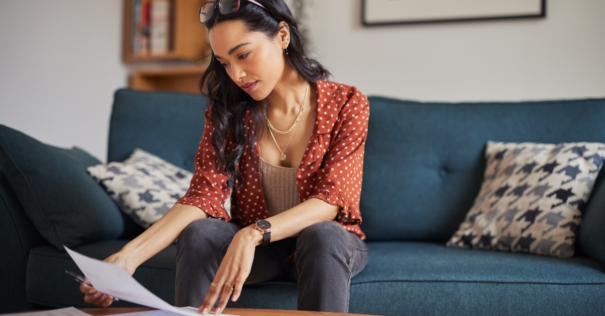 Woman reading bills at home