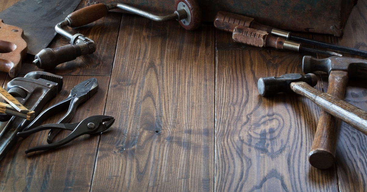 antique toolbox with tools on floor