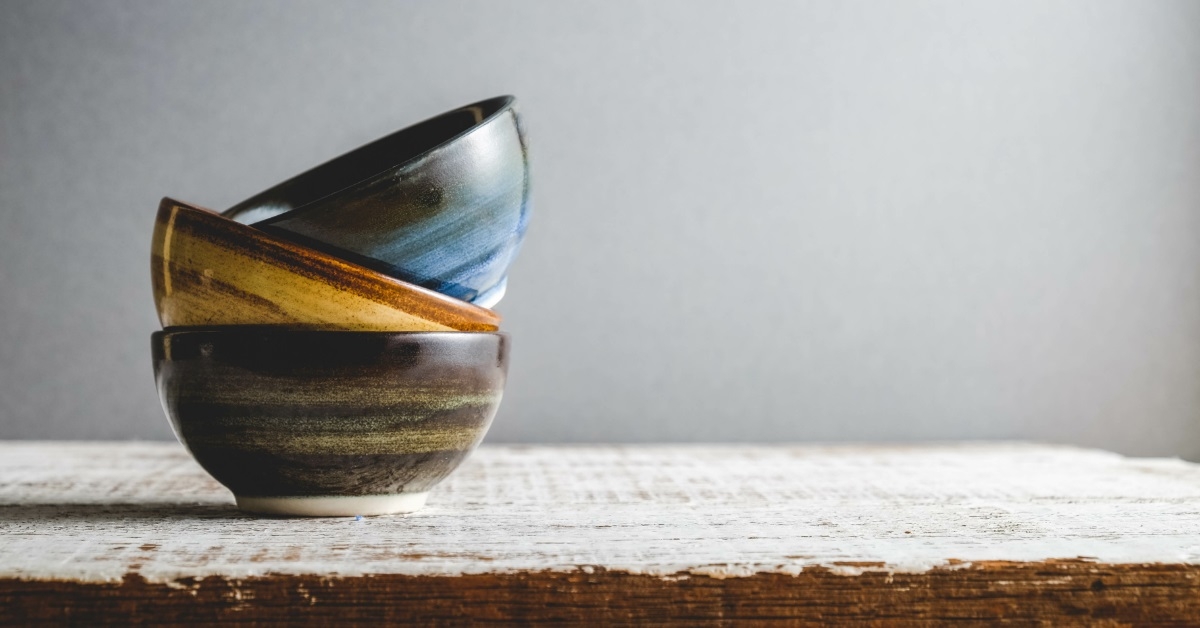 colorful ceramic pots on wooden table