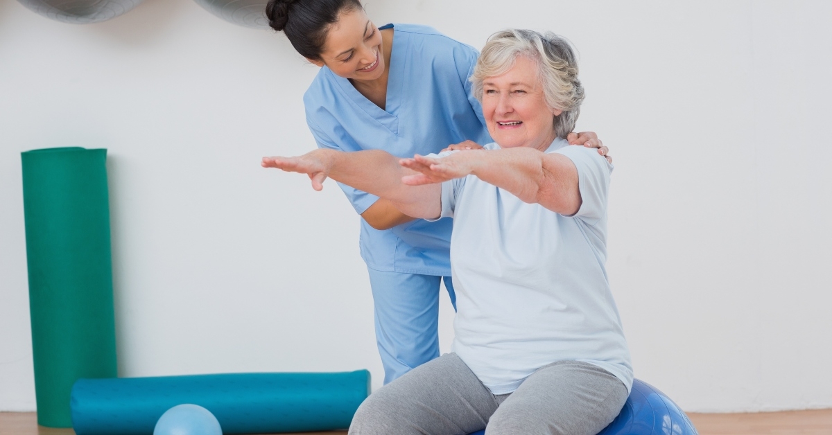 assisting senior woman in exercising