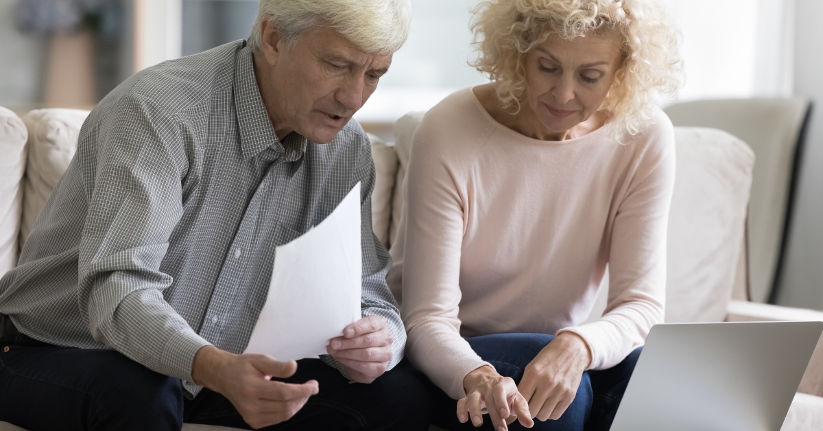 married couple checking paper bills