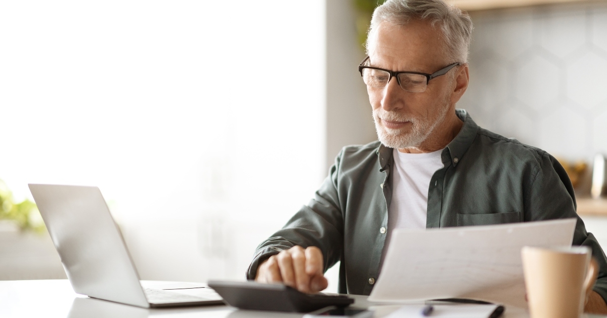 Senior Gentleman Calculating Taxes