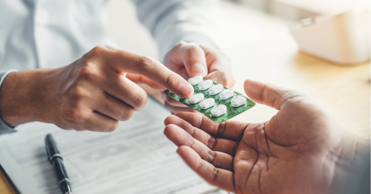 doctor prescribing pills to male patient