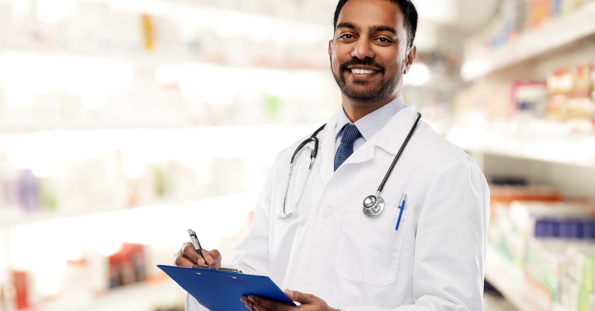 confident young doctor posing with clipboard