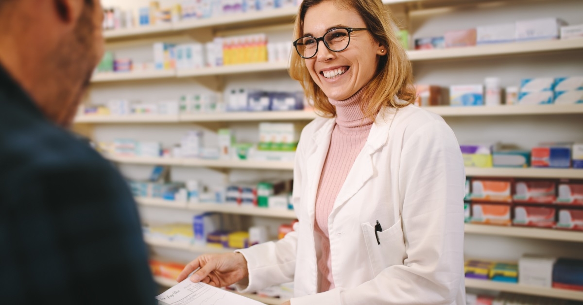 female pharmacists assisting male client