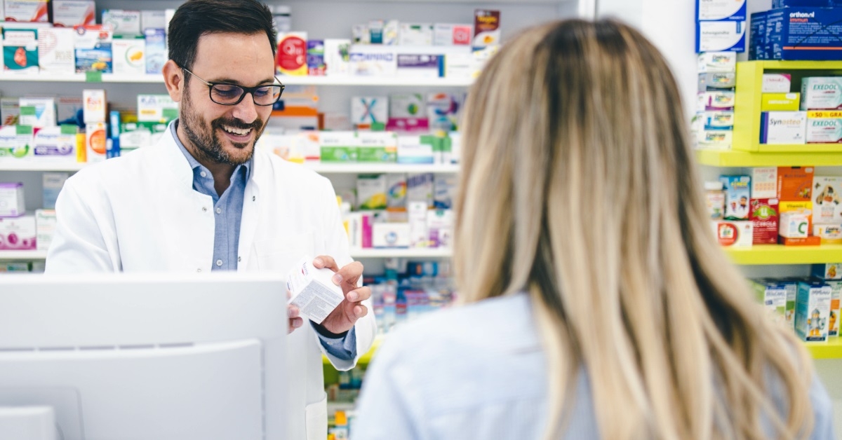 male pharmacist explaining product to client