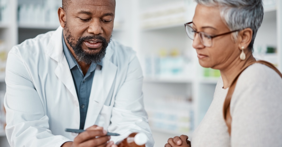 male pharmacist giving instructions to client
