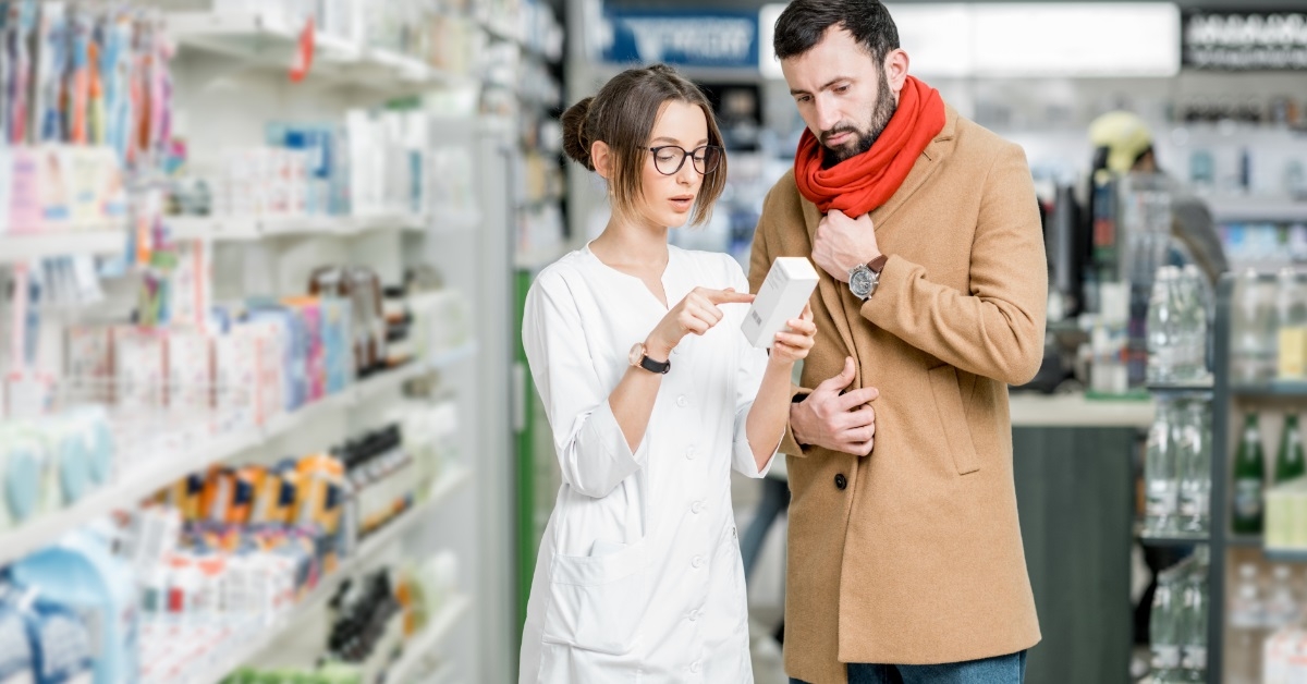 female pharmacist giving medicine to patient