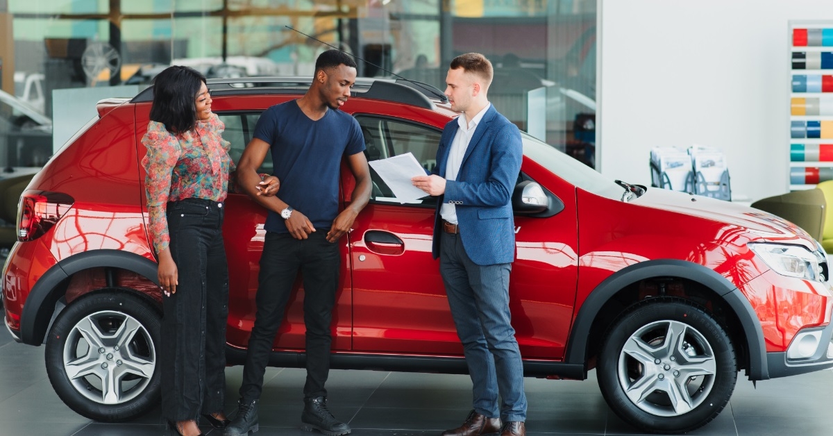 african couple buying car from dealer