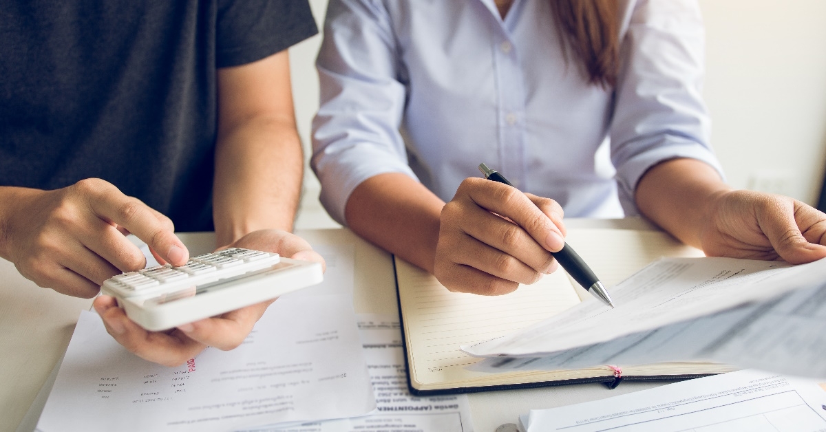 happy couple analyzing budget together