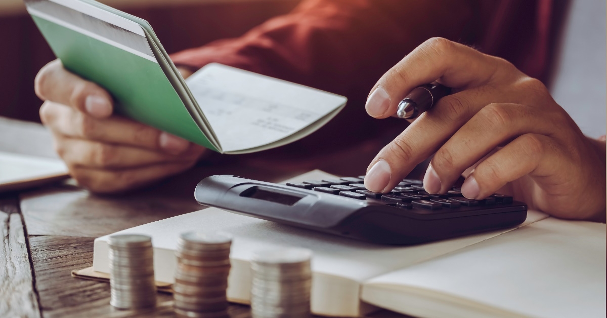 man using calculator on table