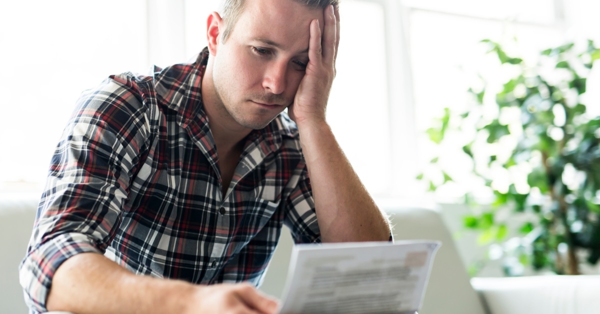 frustrated man reviewing bill