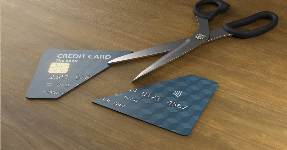 credit card in half besides scissor