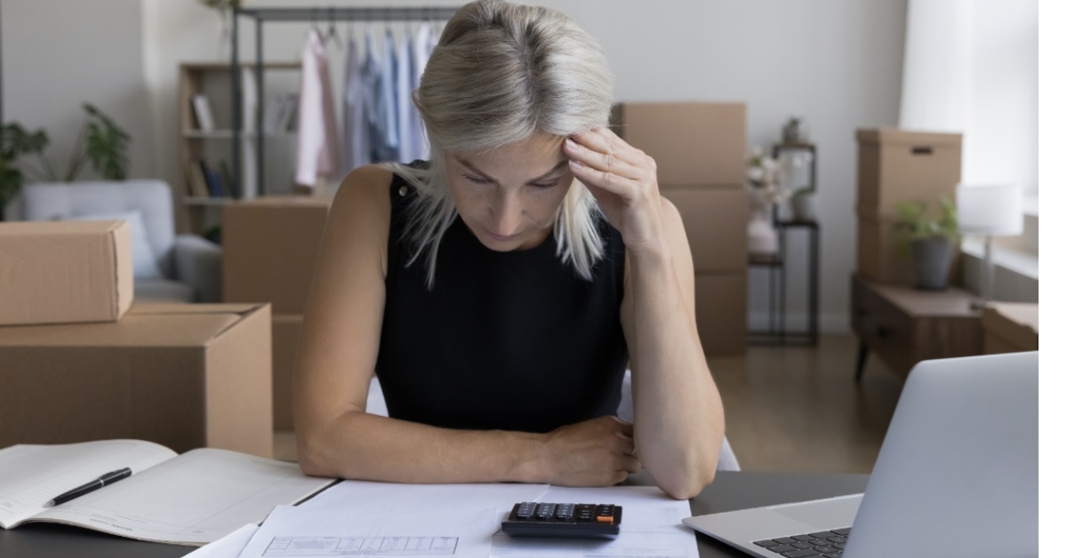 woman stressing while reviewing bills