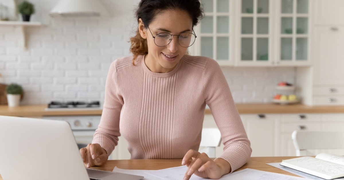 woman calculating bills using calculator