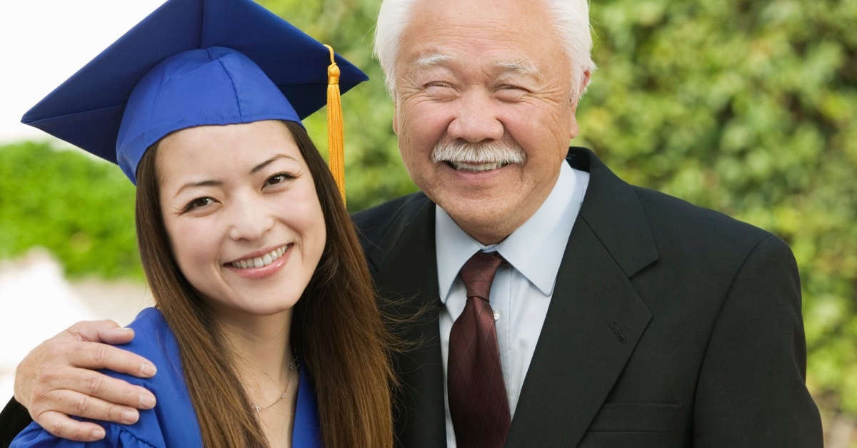 daughter with father at graduation ceremony