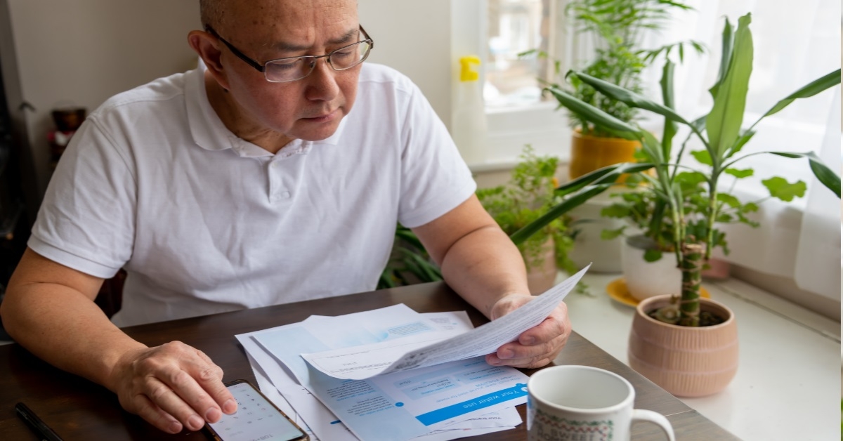 senior man calculating utility bills 