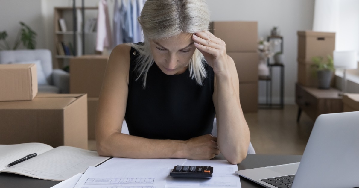 stressed senior woman reviewing bills