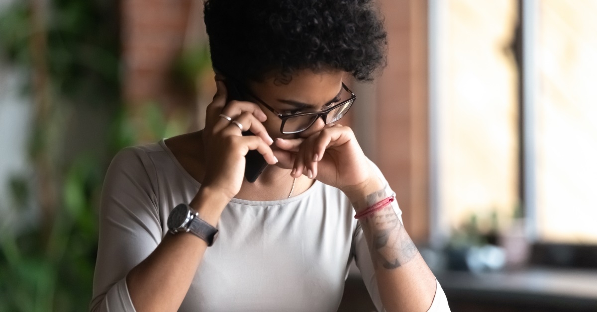 upset african american woman on call