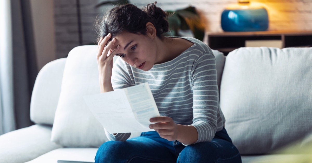 stressful woman reviewing bills at home