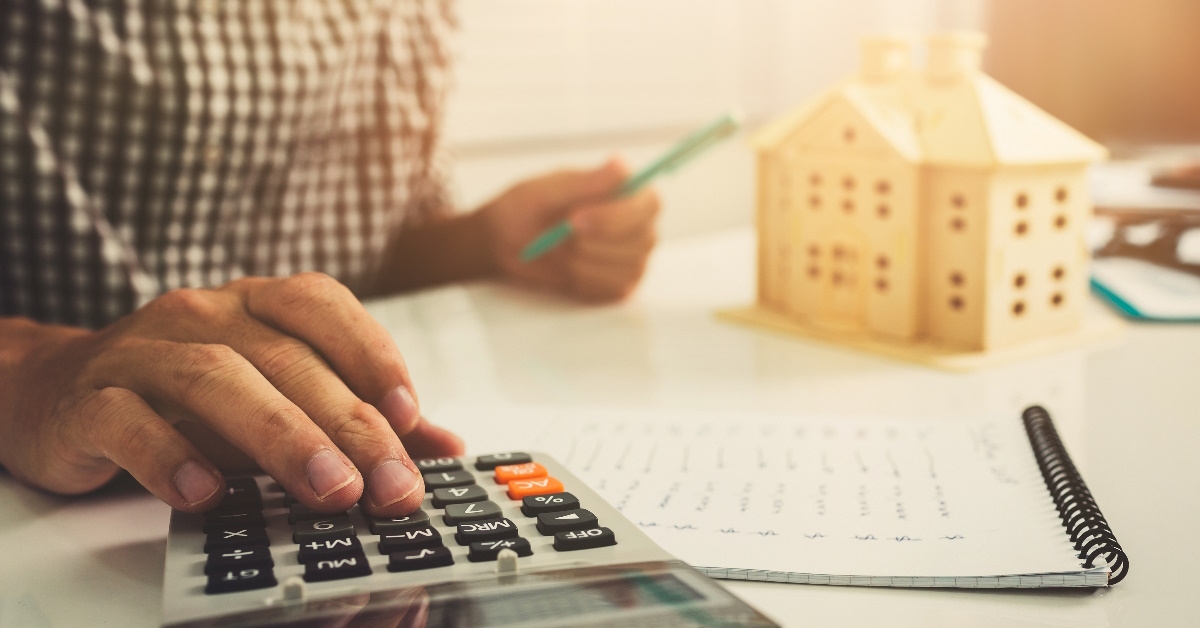 man using calculator to calculate mortgage 