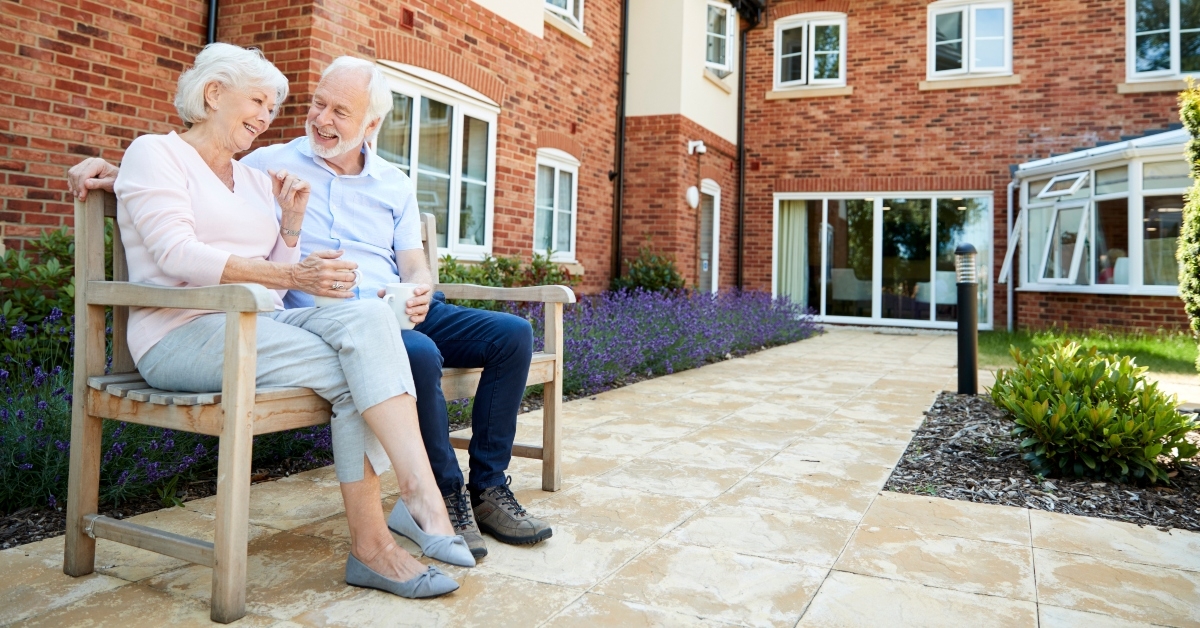 retired couple sitting on bench