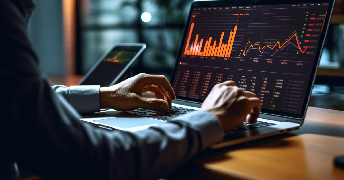 businessman analyzing stock graphs using laptop