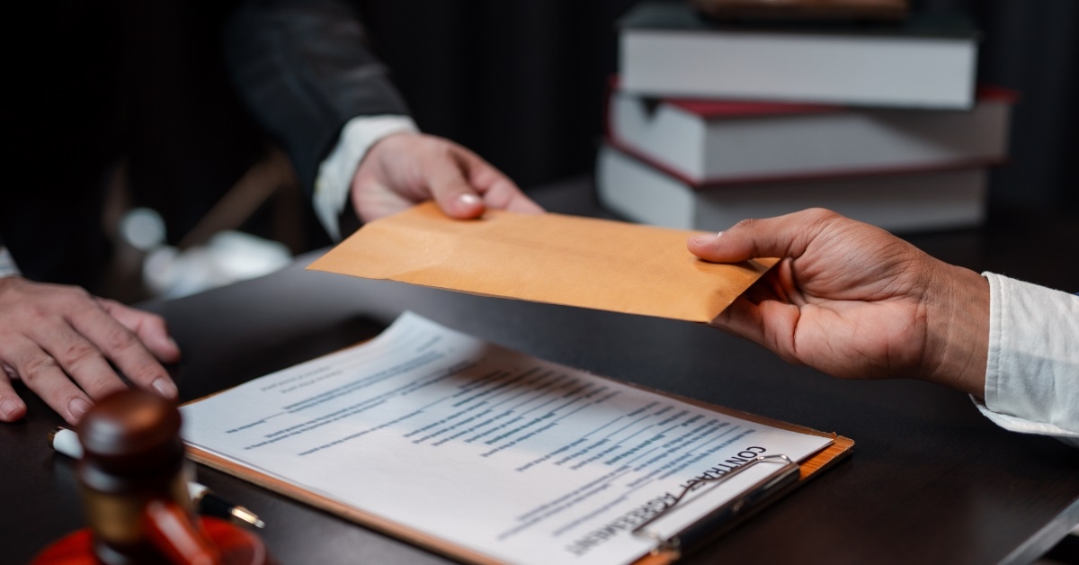 man bribing lawyer by giving envelope