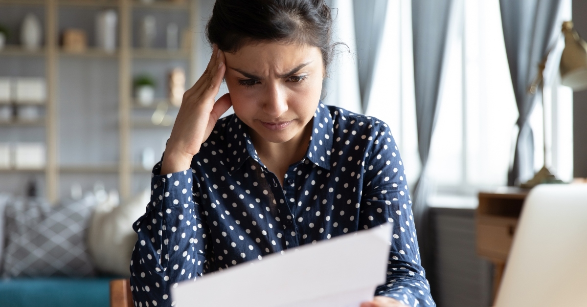 woman sit at desk hold document