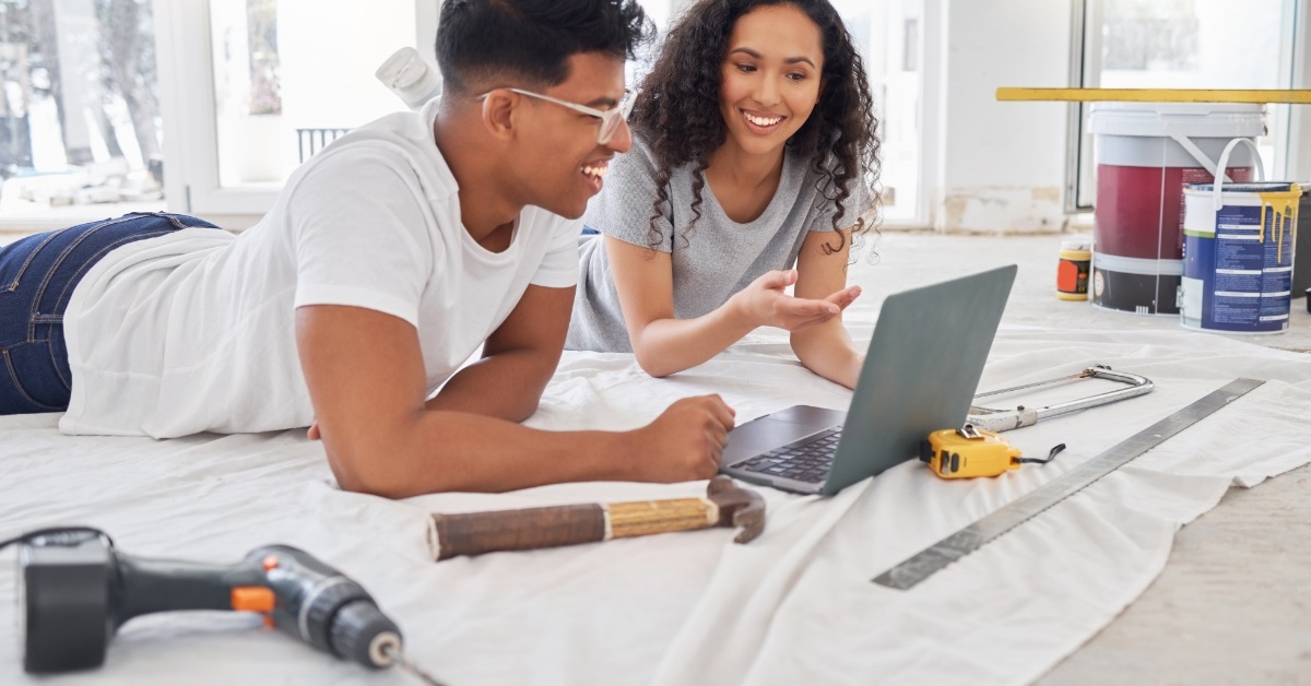 couple getting renovation ideas using laptop
