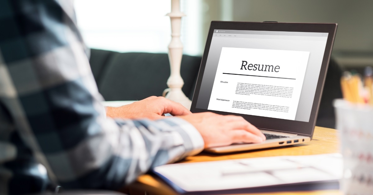 man modifying resume using laptop