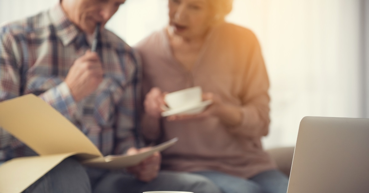 senior couple checking documents at tea