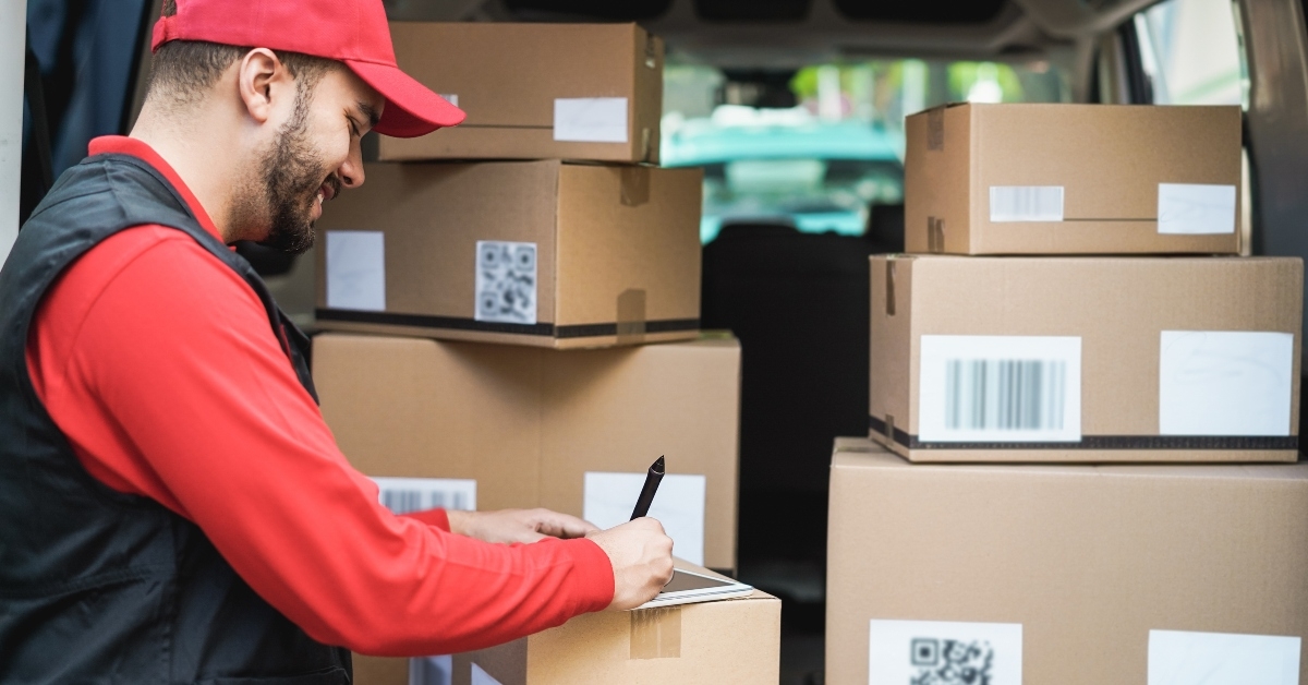 courier man with signing on tablet