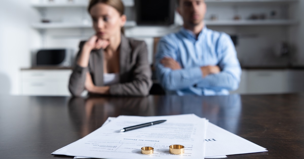 sad couple with divorce documents